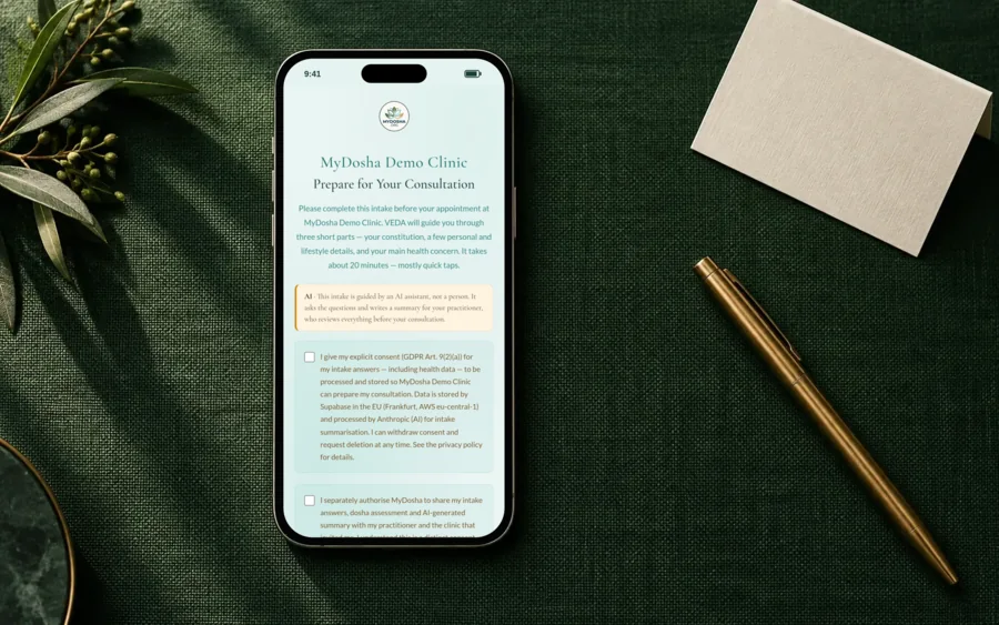 The MyDosha patient intake open on a phone lying on a desk, at the consent step